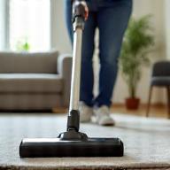 Cleaner vacuuming modern living room